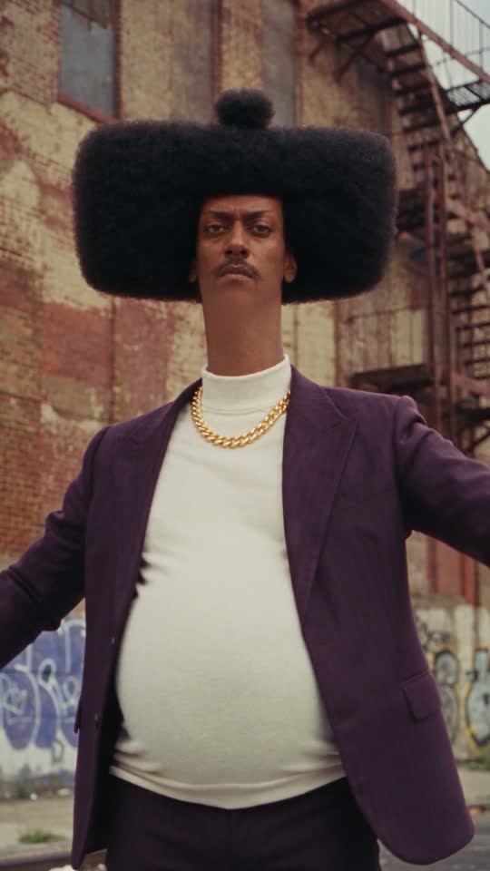 Phil standing in a brick-lined street, moments before an absurd kung-fu performance.